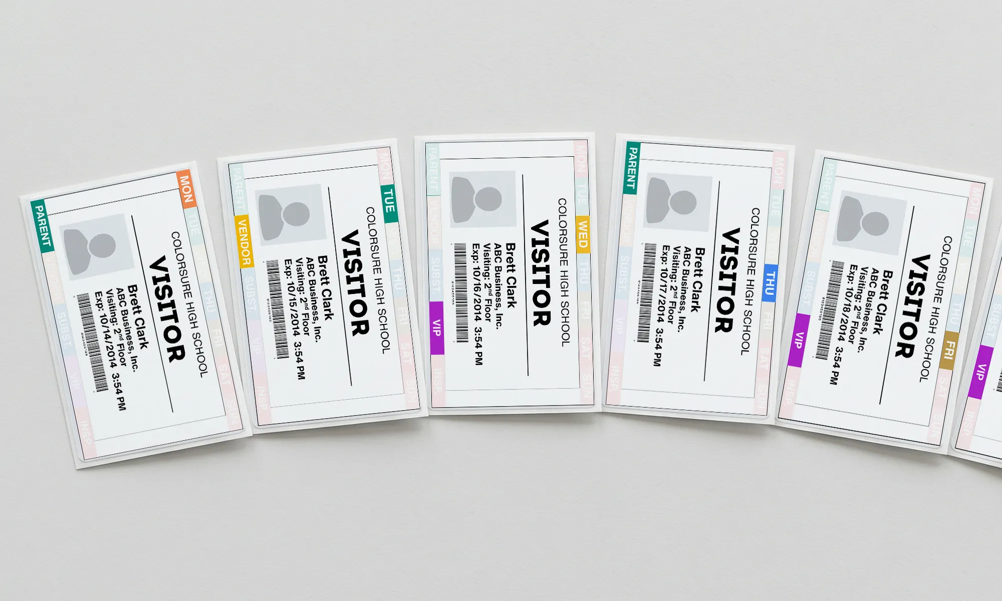 A row of visitor badges showing day-of-week and visitor-type color bands