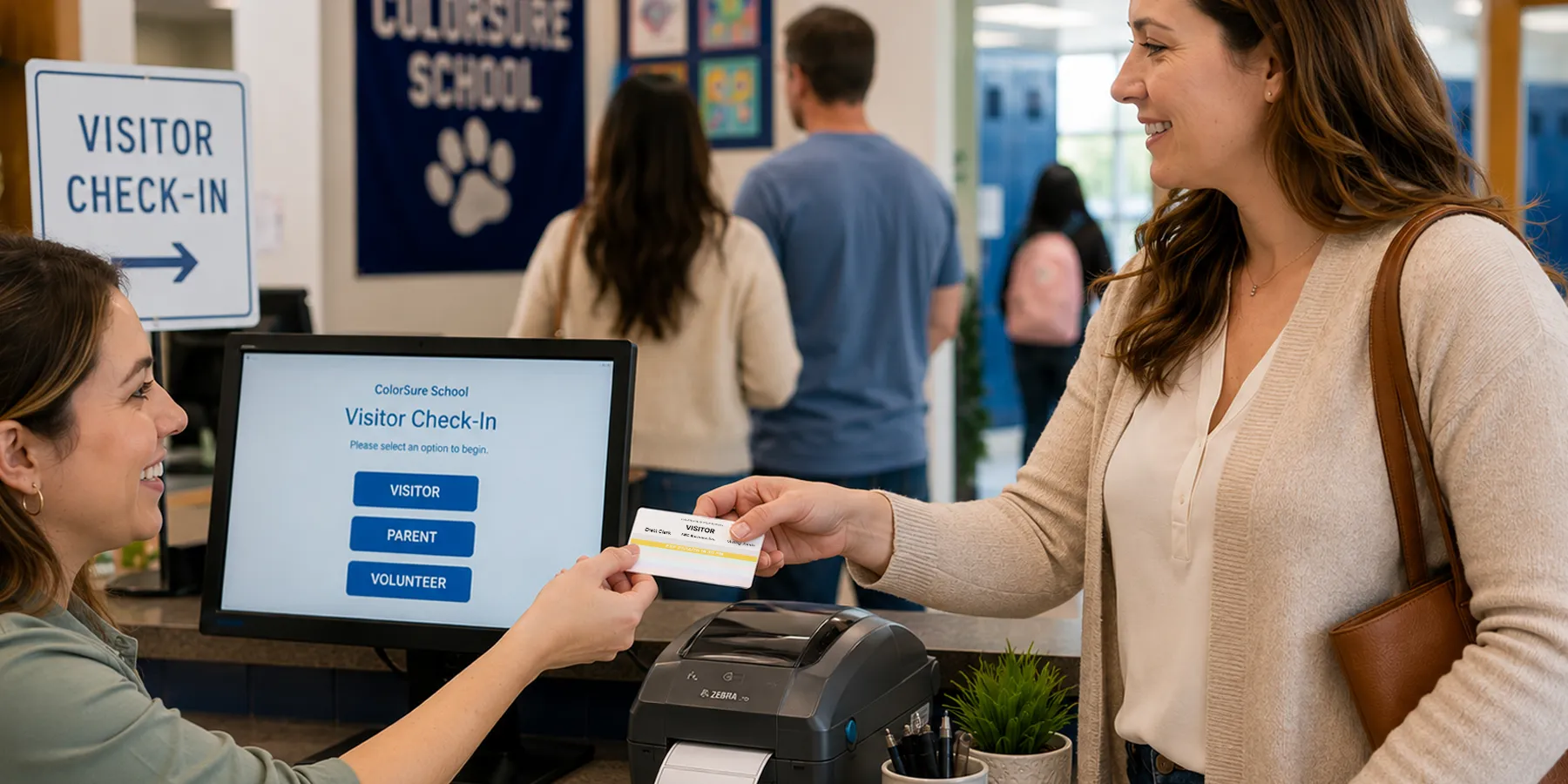 A school receptionist handing a color visitor badge across the front desk