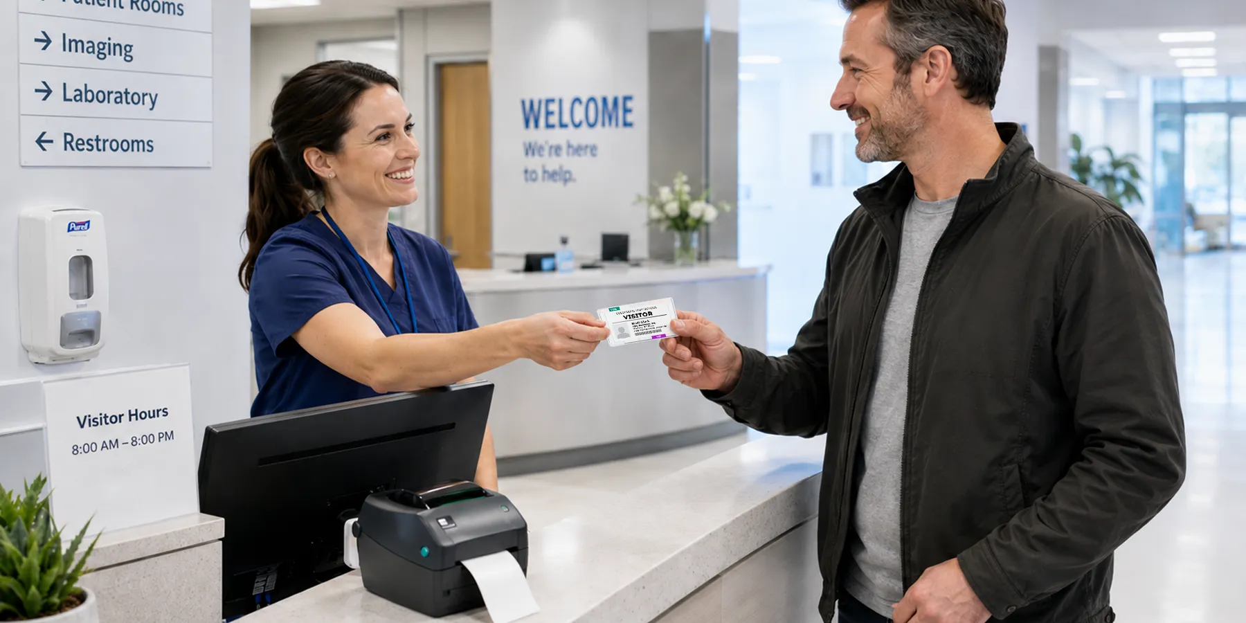 A hospital visitor wearing a color-coded badge at a clinical reception desk