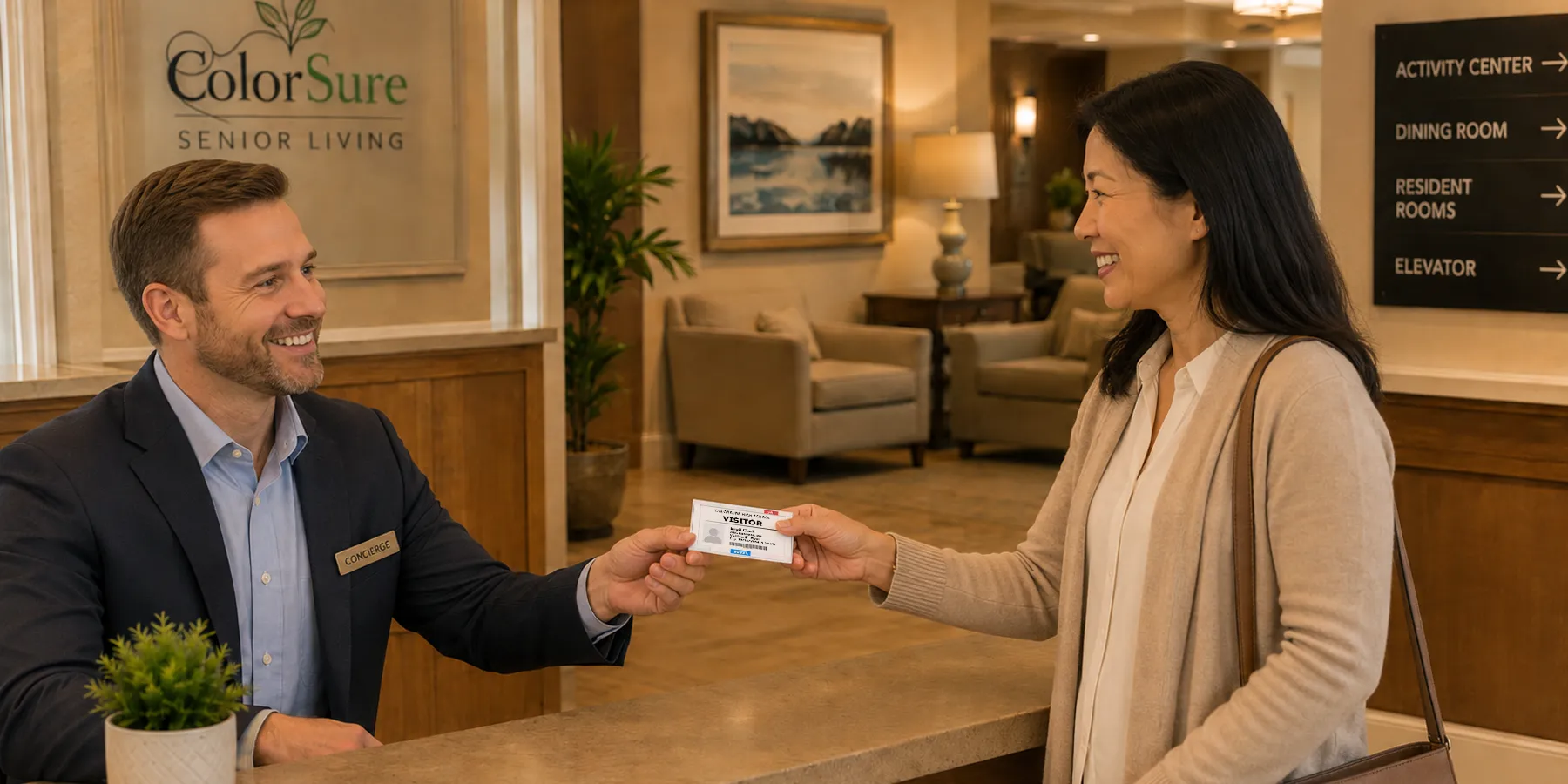 A family visitor wearing a color badge at a senior living reception desk